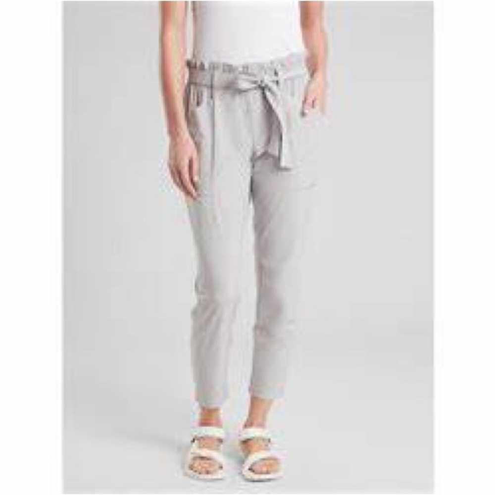 NWOT Athleta Skyline Paperbag Waist pants with tie belt in light grey.